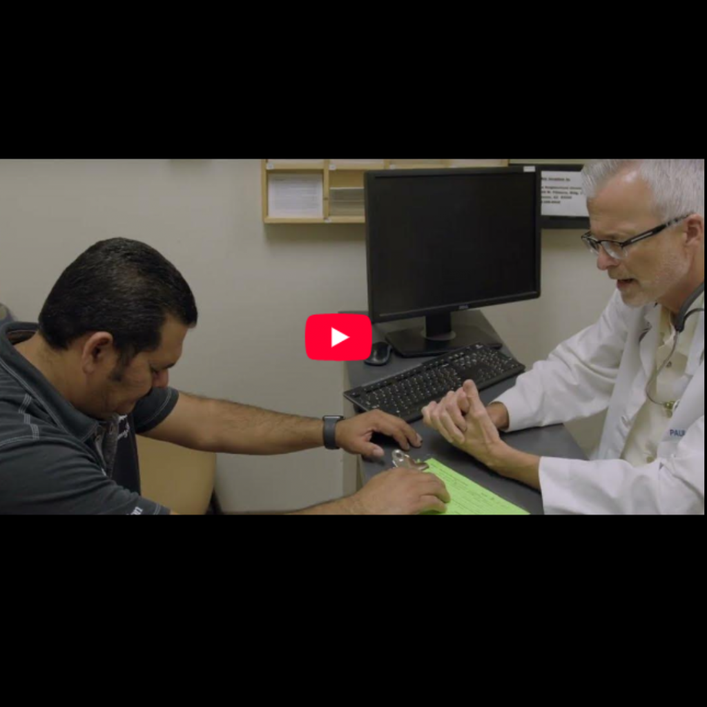 Dr Paul prays with a Patient at the Neighborhood Christian Clinic