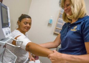 Nurse taking a woman's vitals