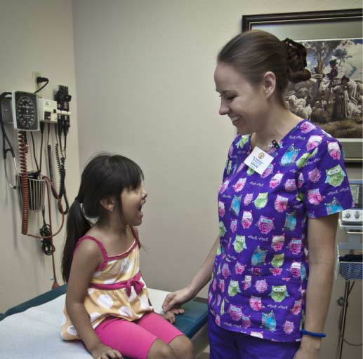 Nurse offering healthcare to young girl