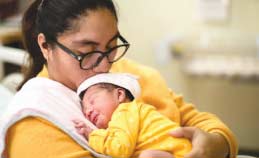 Woman kissing her baby