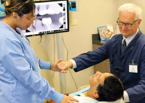 Man being prayed over before dental procedure