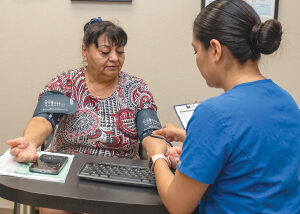 Woman getting blood pressure checked