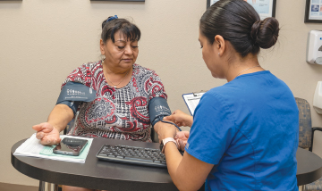 Woman getting blood pressure checked