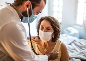 Woman getting heart checked by doctor