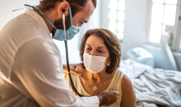 Woman getting heart checked by doctor