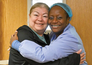 Patient and a nurse hugging